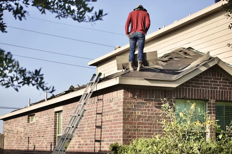 Professional roofer working on a residential roof in Knoll View Acres
